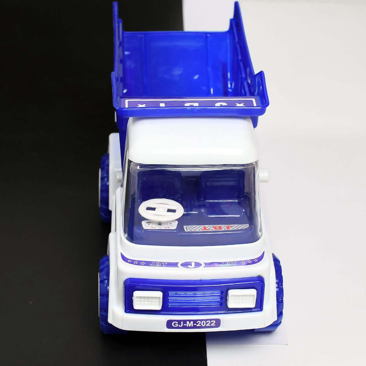 friction powered dumper truck for kids in blue and white design with tipping container
