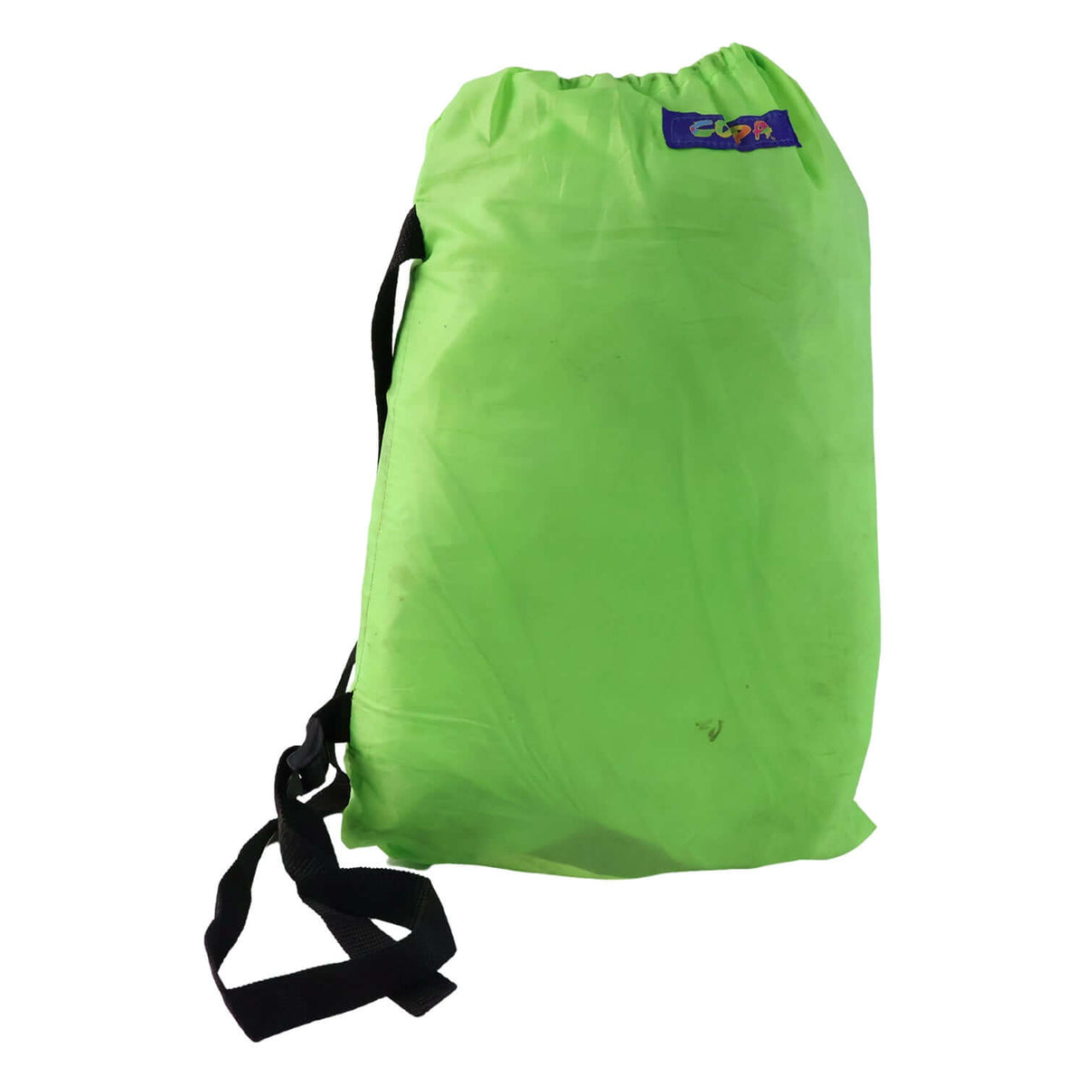 Inflatable air lounger for outdoor use packed in a bright green carry bag with a strap.