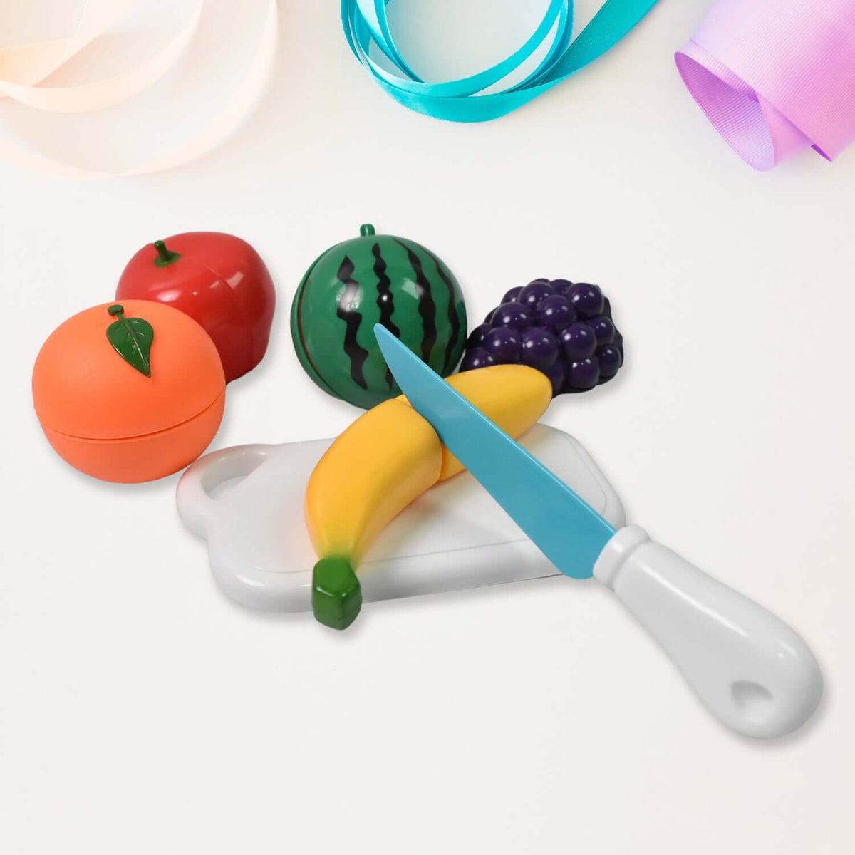 Sliceable fruit cutting play toy set with banana, orange, watermelon, grapes, knife, and chopping board.