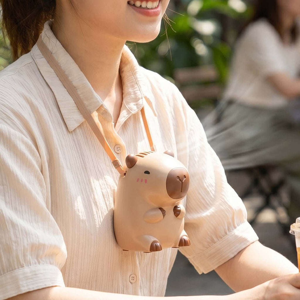 Cute bear neck fan worn as a necklace for personal cooling on a sunny day.