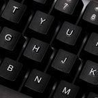 Close-up of black keys on a 104-key backlit gaming keyboard and mouse set, showcasing floating keycap design.