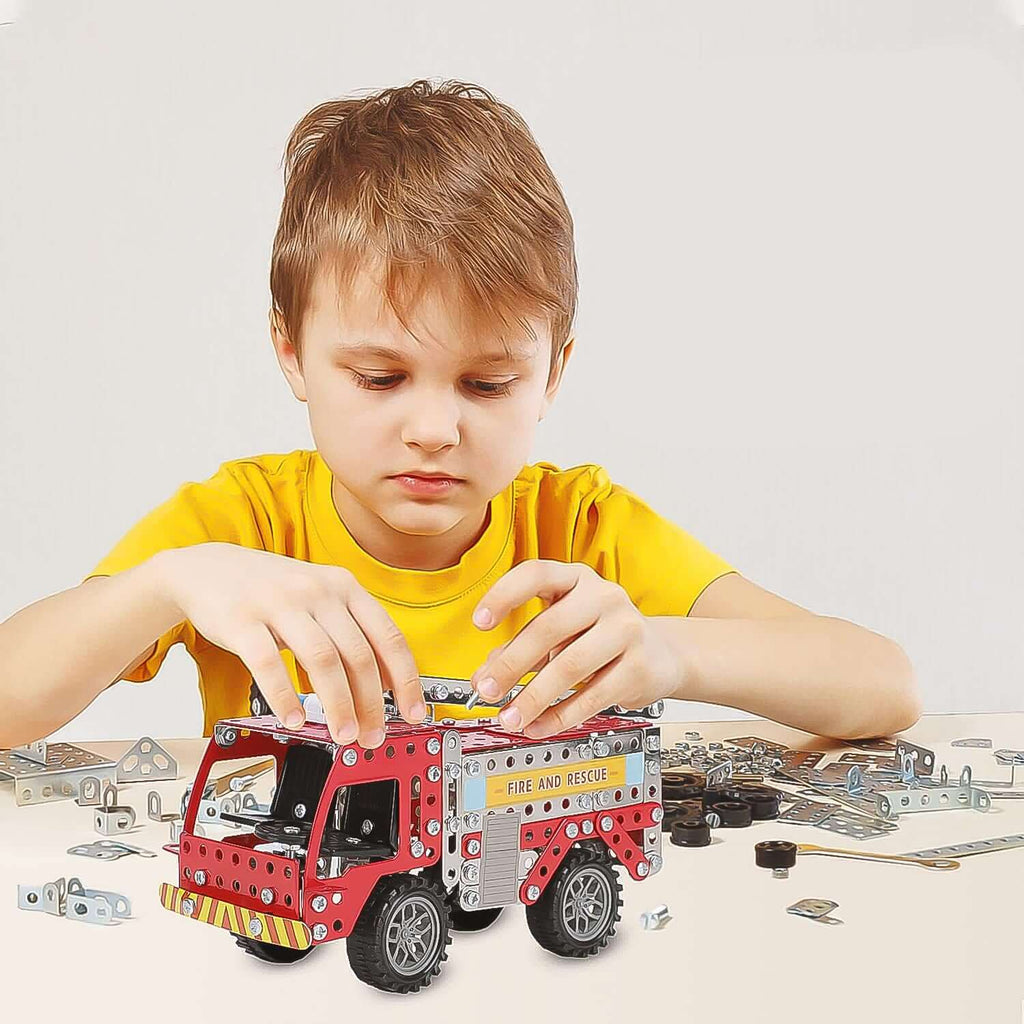 Child assembling 292-Piece Metal DIY Fire Truck Building Blocks with metal parts and tools.