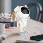 Astronaut Galaxy Projector Night Lamp on a desk, showcasing its cute design and functionality.