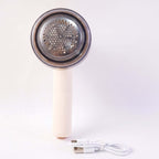 Rechargeable lint remover for clothes with stainless steel blade and USB charging cable.