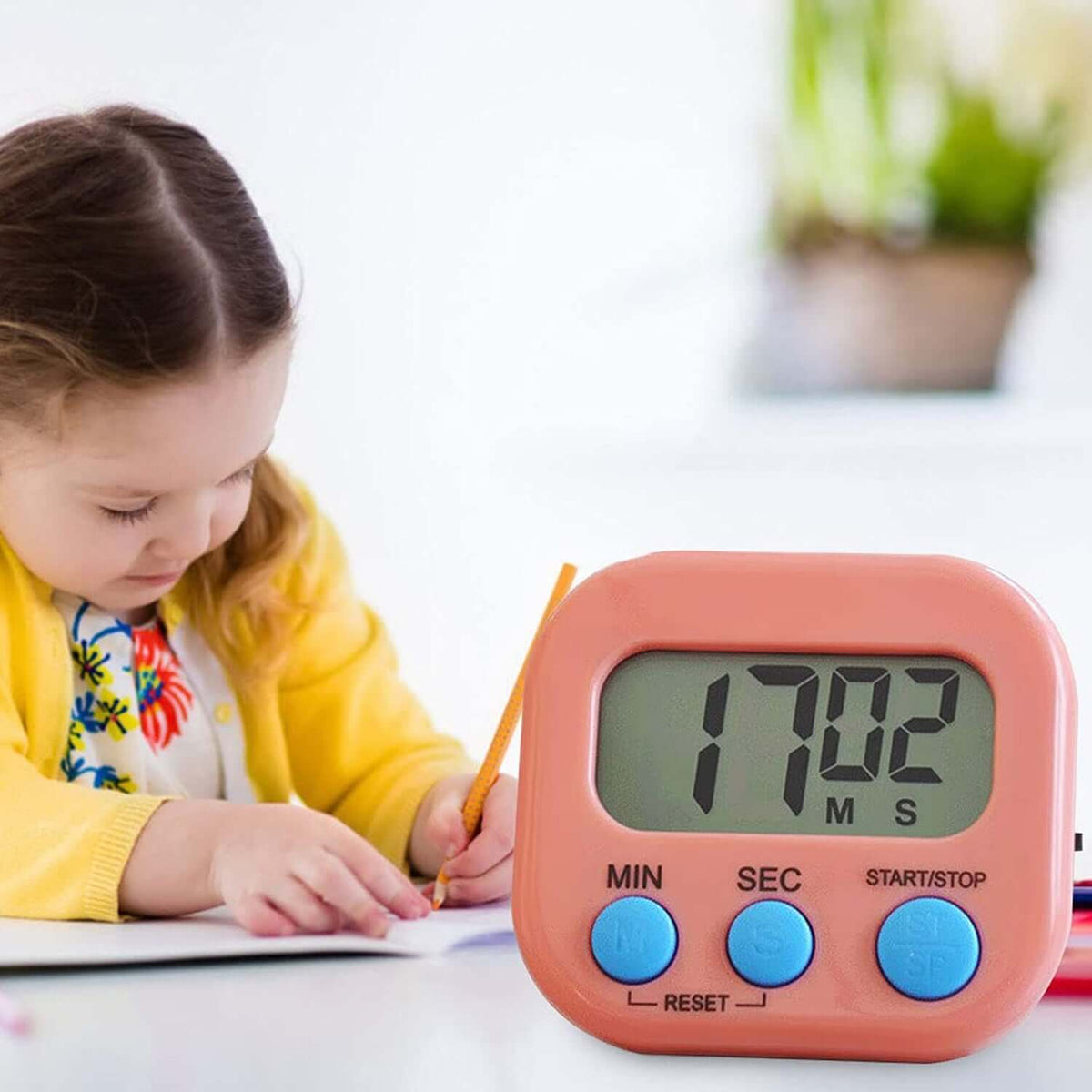 Digital kitchen timer big digits displaying 17:02, with a child using it while drawing.