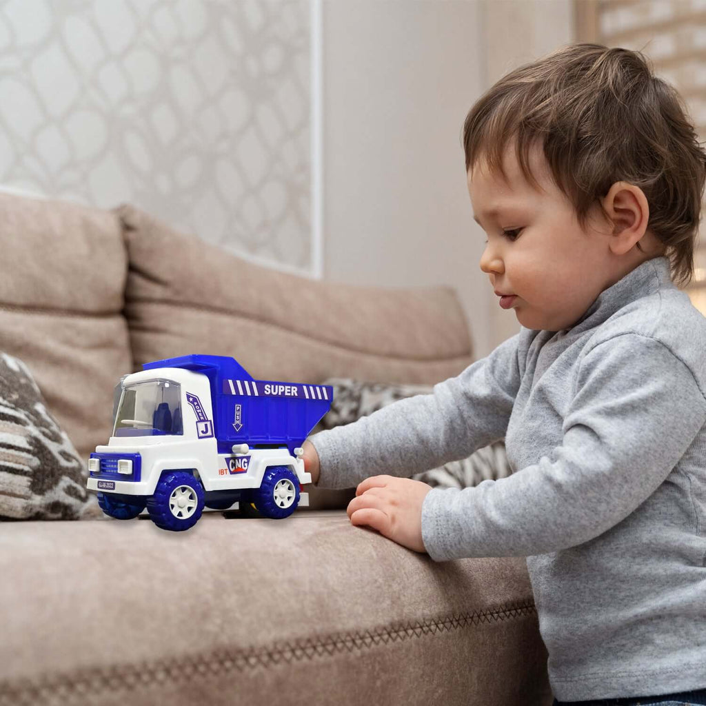 Big Friction-Powered Dumper Toy Truck for Kids being played with by a toddler on a couch.