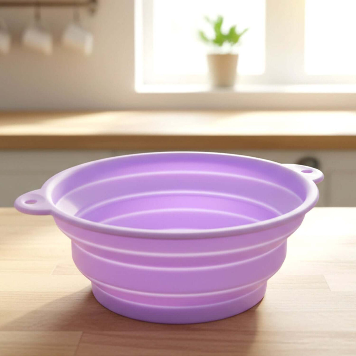 Multipurpose folding silicone bowl in purple, collapsible silicone facial ice bath bowl on wooden countertop.