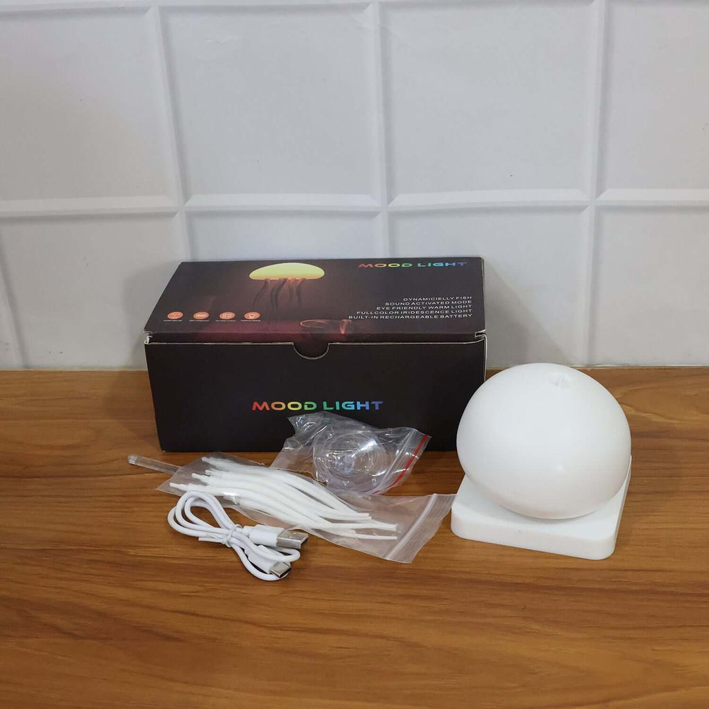Jellyfish LED Mood Light Lamp (1 Pc) displayed with its box and accessories on a wooden table.