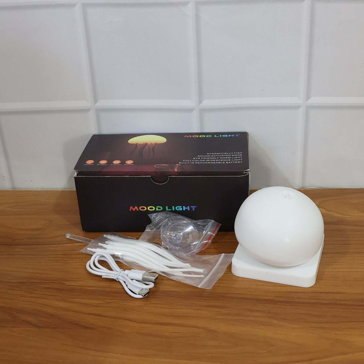 Jellyfish LED Mood Light Lamp (1 Pc) displayed with its box and accessories on a wooden table.