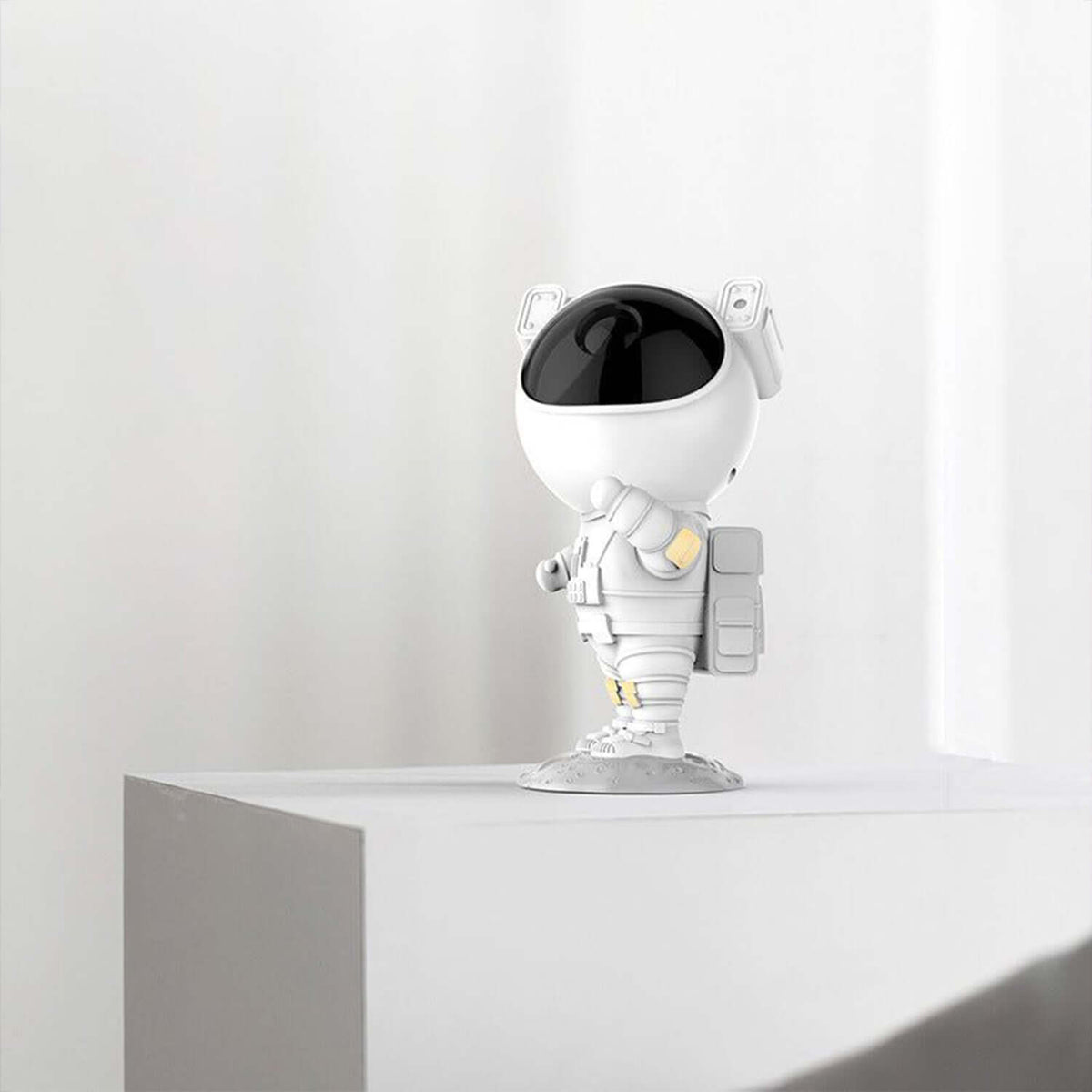 Astronaut Galaxy Projector Night Lamp on a white surface, designed to project moving galaxies and stars.