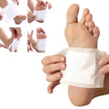 Person applying ginger detox foot pads on their foot for overnight rejuvenation and detoxification.