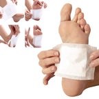 Person applying ginger detox foot pads on their foot for overnight rejuvenation and detoxification.