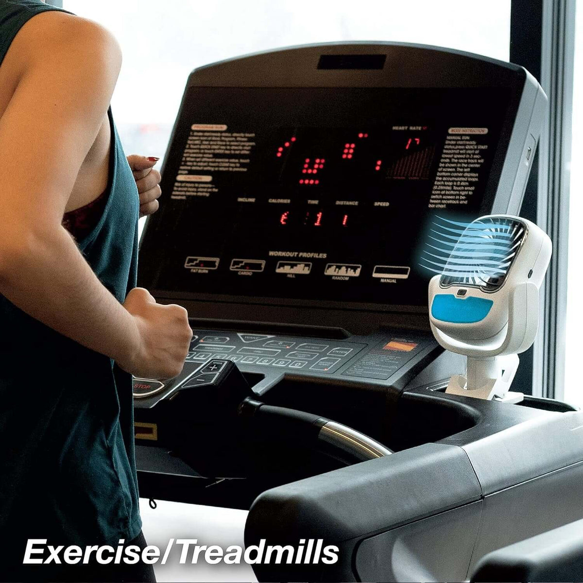 Portable clip fan with LED light attached to a treadmill for cooling during exercise.