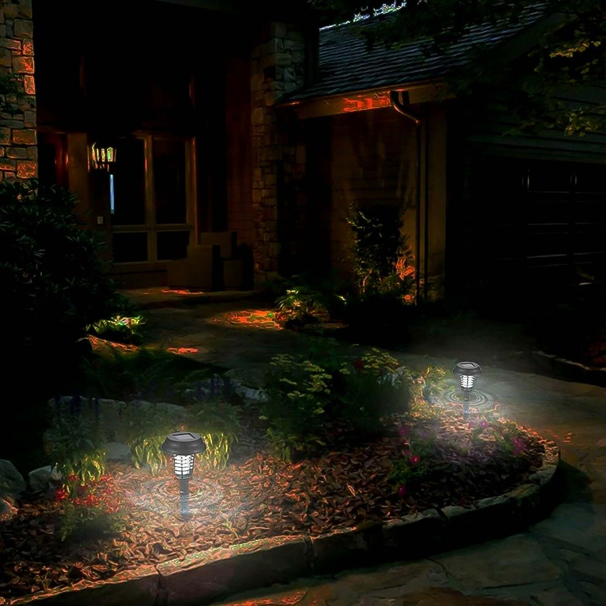 Two Solar UV Mosquito Trap Garden Lights illuminating a garden pathway at dusk.