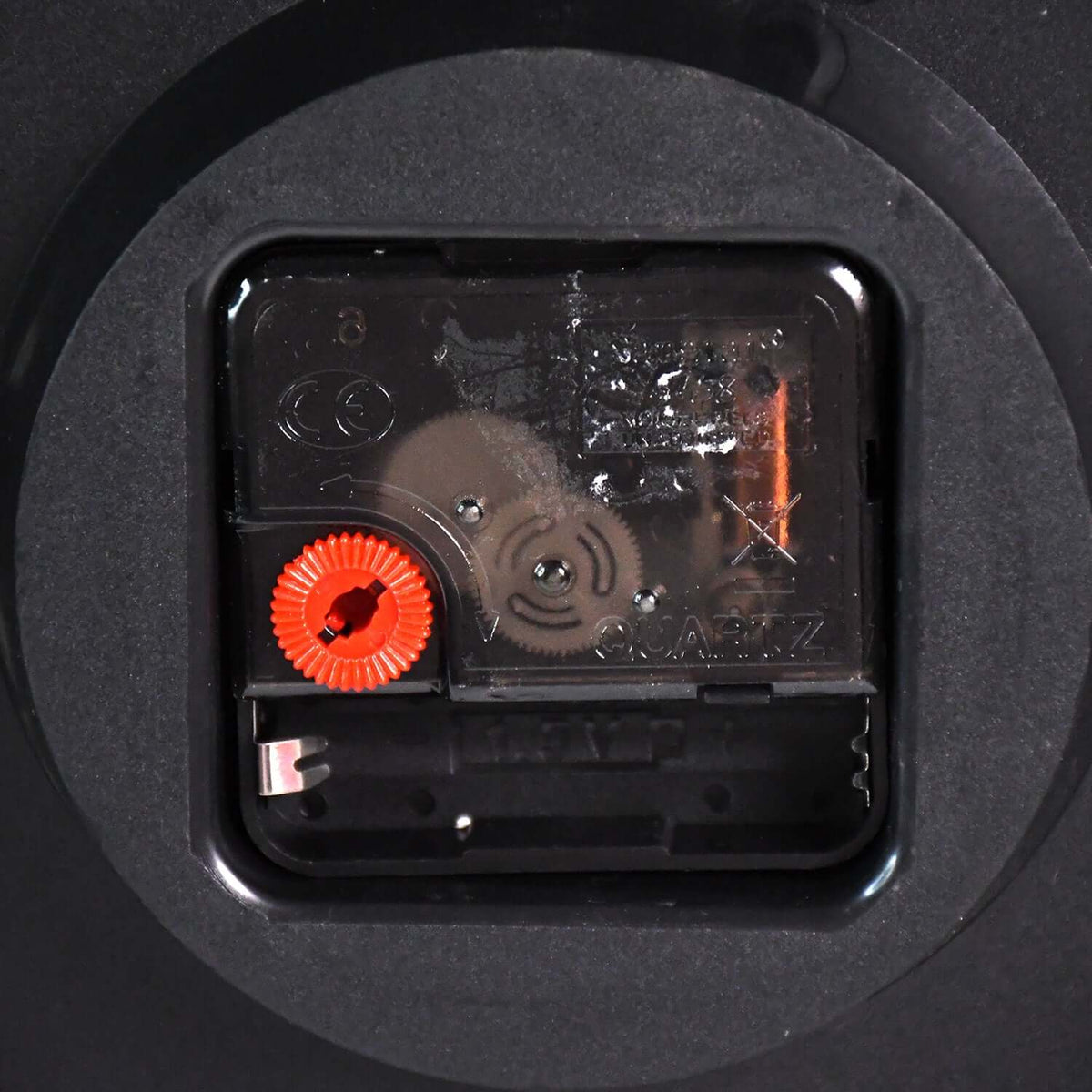 Back view of the Radha Krishna decorative wall clock mechanism with quartz movement and adjustment knob.
