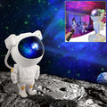 Astronaut galaxy projector night lamp illuminating a cosmic scene in a bedroom setting with remote control.