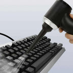 3-in-1 rechargeable car vacuum cleaner cleaning a keyboard with blower feature for efficient debris removal