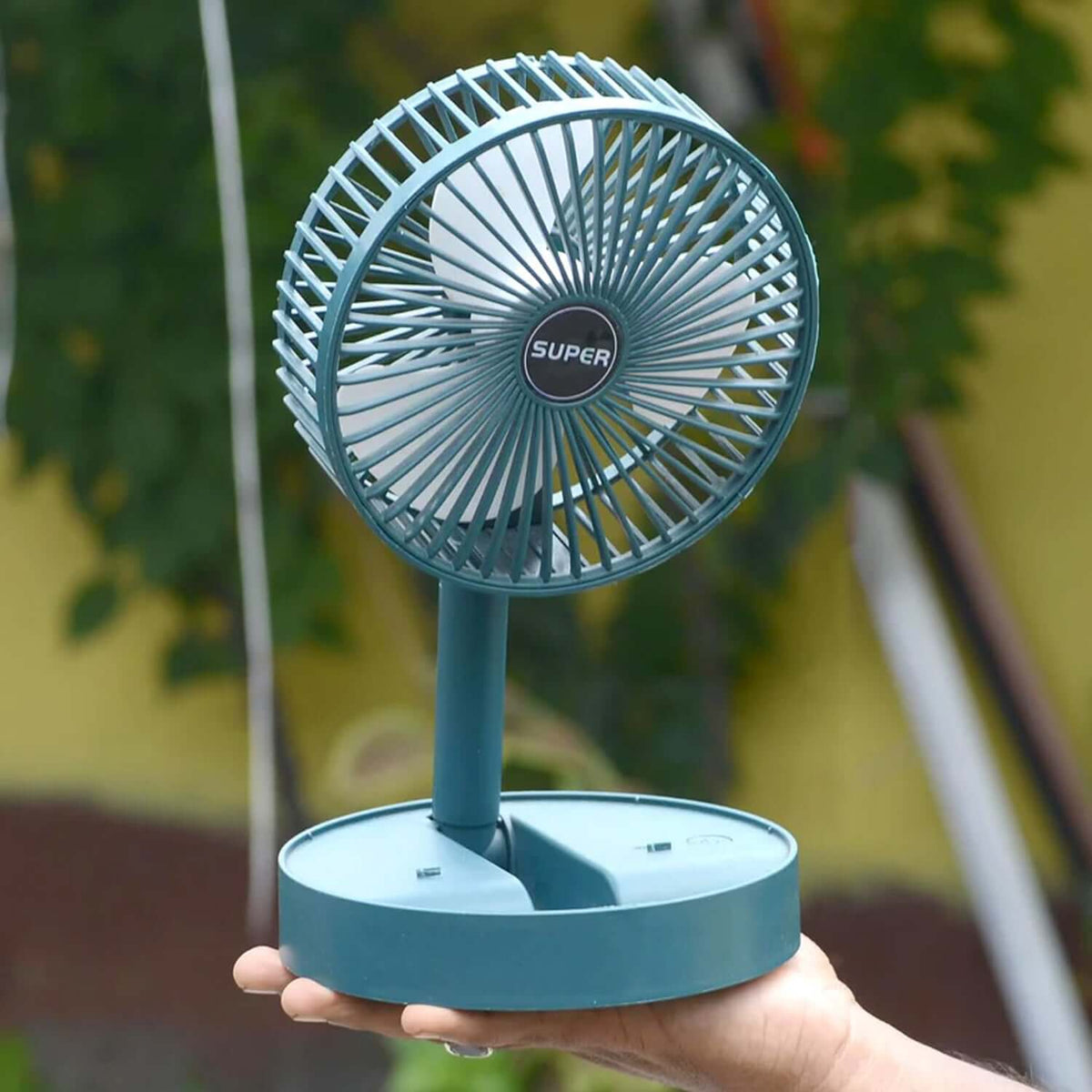 Foldable mini USB desk fan with adjustable height, ideal for work or personal use.