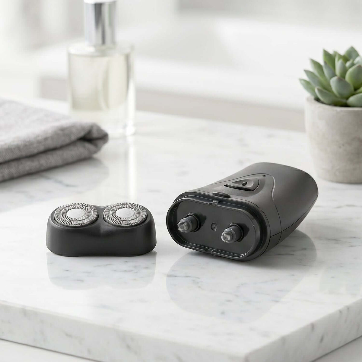 Portable cordless electric shaver for men on a marble countertop next to a small plant.