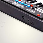Close-up of a 37-key kids piano keyboard microphone with various buttons and connections.