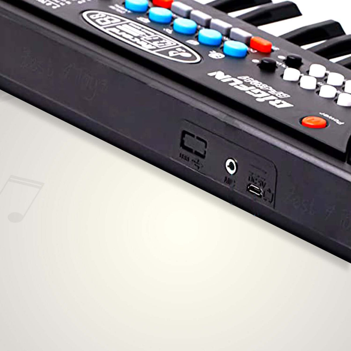 Close-up of a 37-key kids piano keyboard microphone with various buttons and connections.