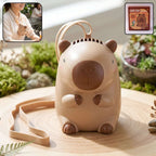 Cute bear neck fan with neck strap displayed on a wooden table in an outdoor setting.