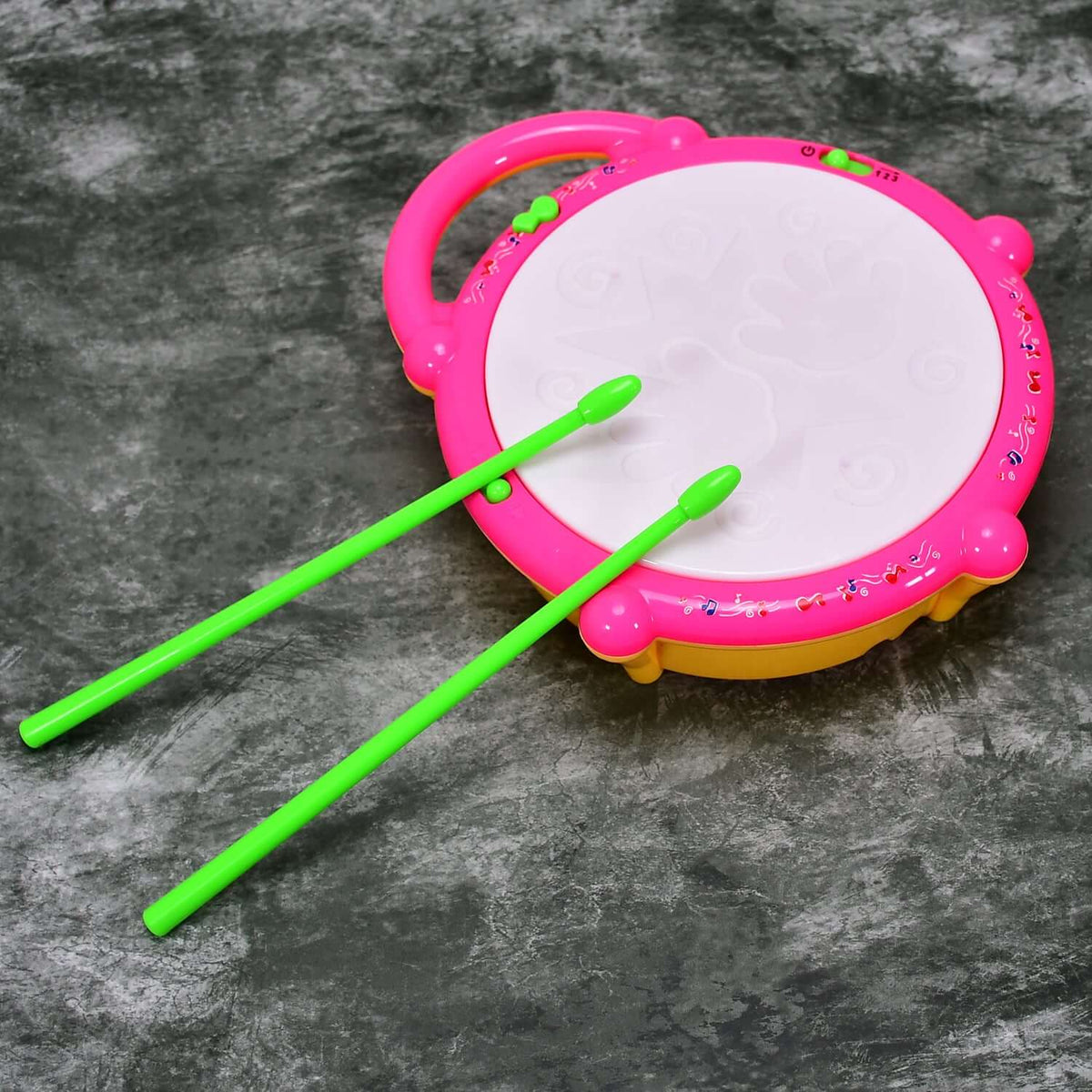 Colorful musical drum toy for kids with vibrant colors and green drumsticks.