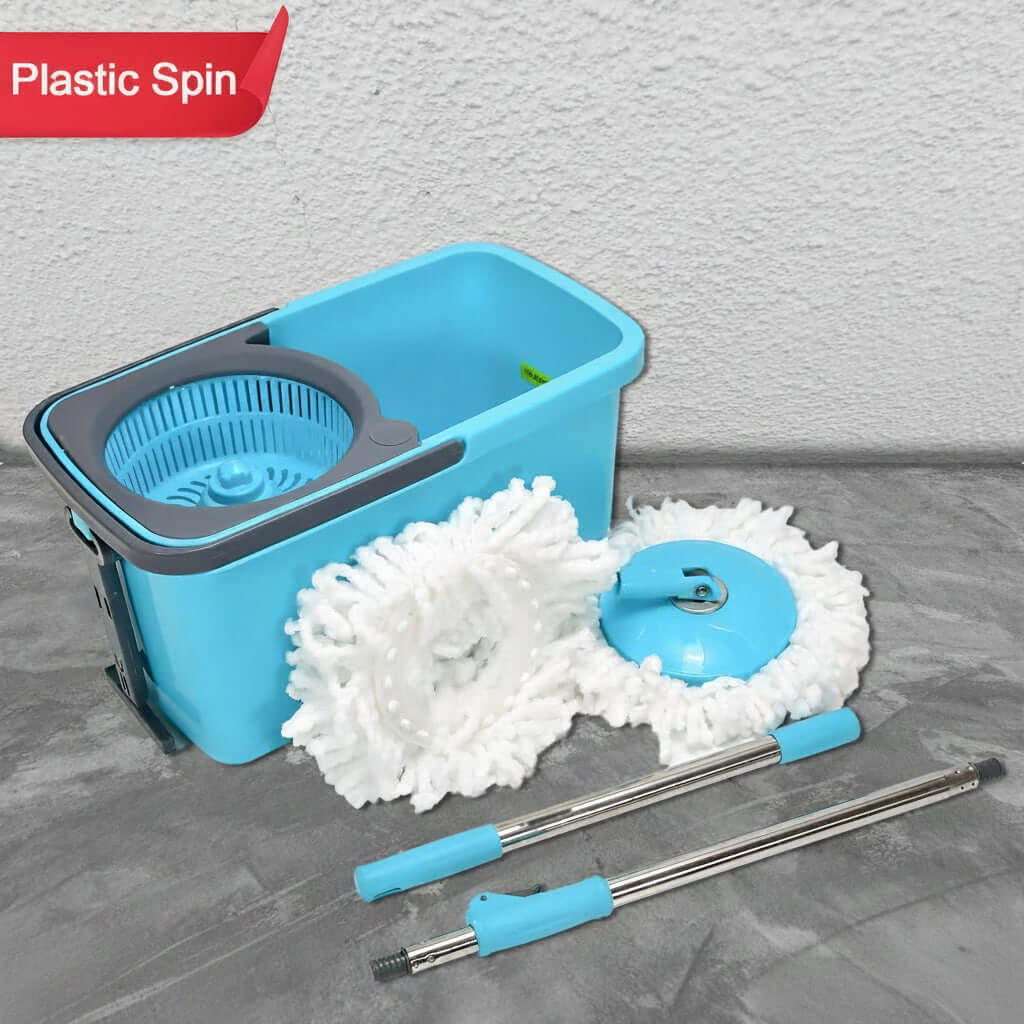 hands-free spin mop with wheeled bucket and two mop heads on a gray surface.